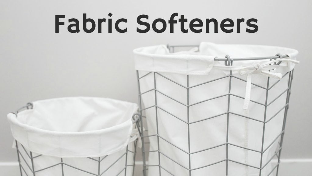 wire laundry baskets with white cloth inserts against gray wall