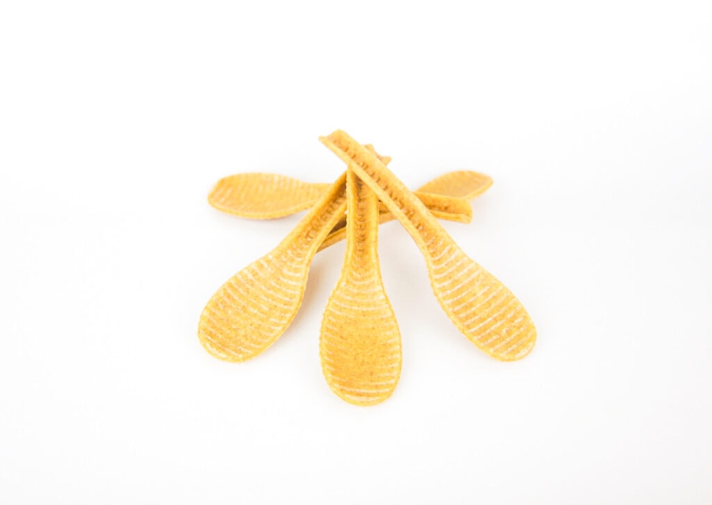 compostable spoons against white background