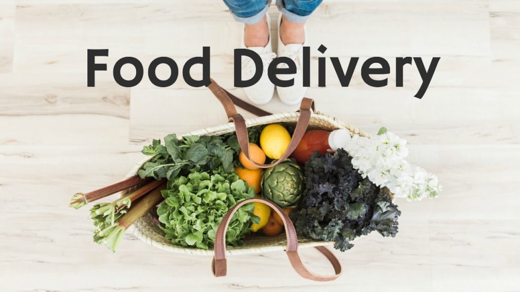 canvas bag with leather handles stuffed with fresh produce and woman wearing sneakers standing nearby zero waste living tips