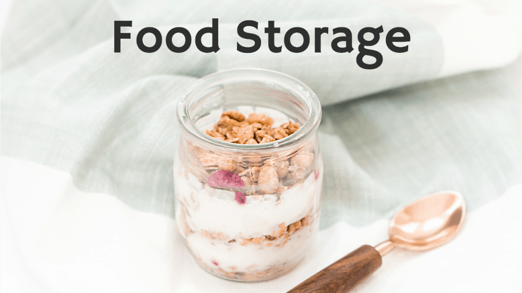 glass jar of granola and yogurt layered for breakfast with spoon beside against blue towel zero waste living tips