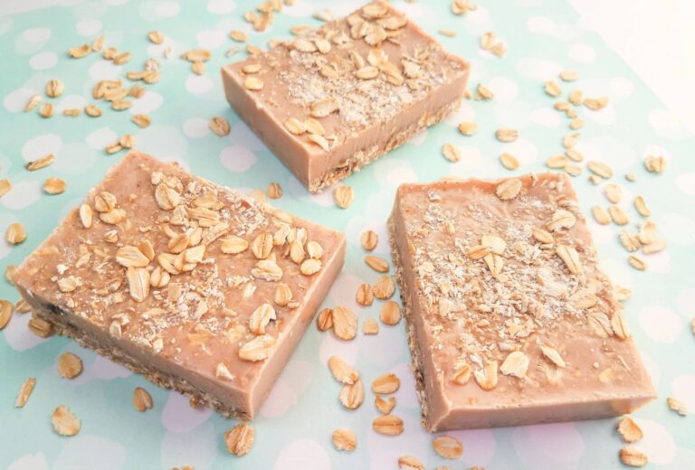 exfoliating cinnamon oatmeal soap bar against blue background