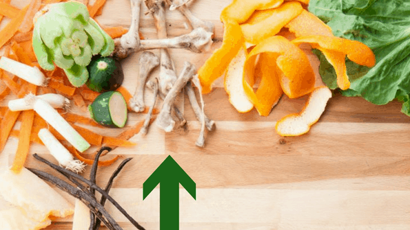 chicken bones and vegetable peels on wooden board