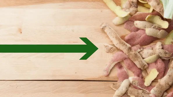 potato peels food waste on wooden cutting board