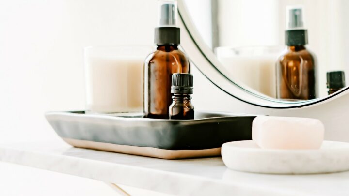 brown glass bottle of oil on bathroom shelf