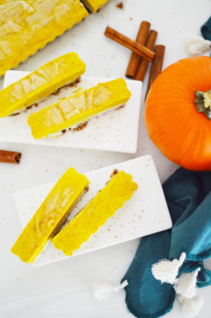 vegan pumpkin cheesecake bars on white plate