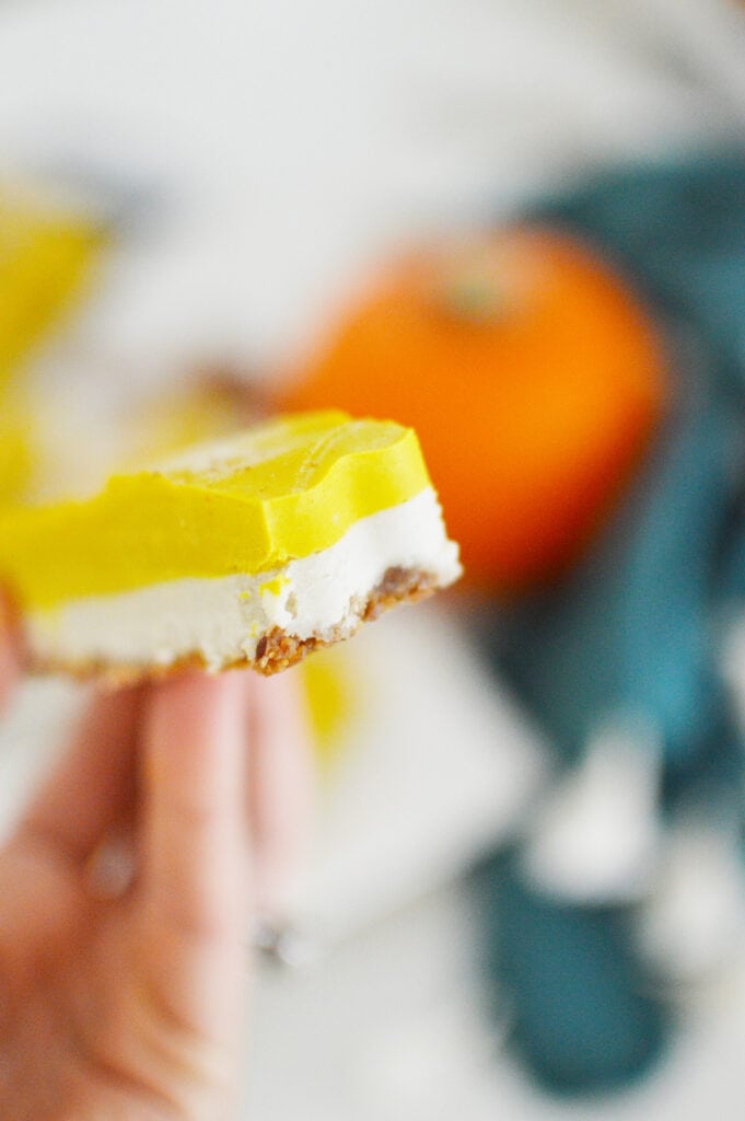 layered pumpkin cheesecake bar with bite taken out