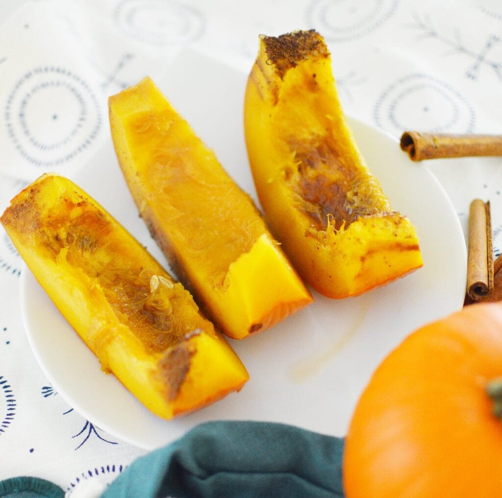 pumpkin slices on white background next to teal dishcloth