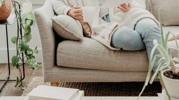 woman sitting on couch reading a book