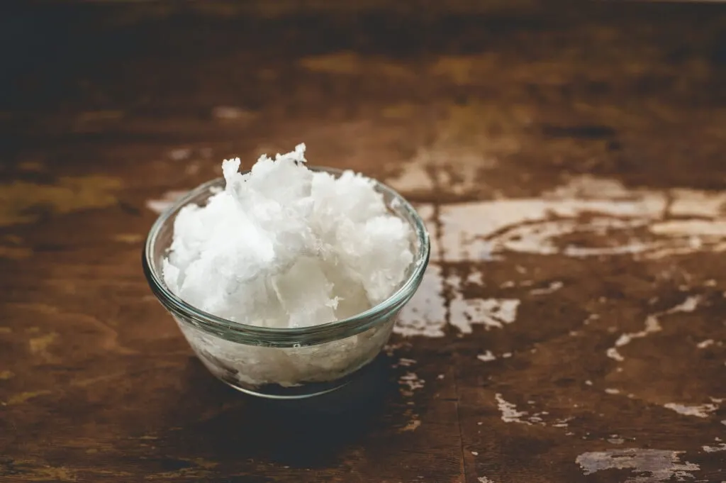 coconut oil in bowl on dark wood background