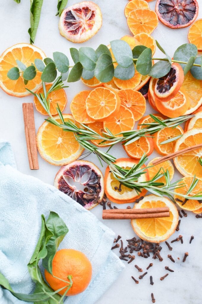 oranges eucalyptus rosemary cloves on marble background