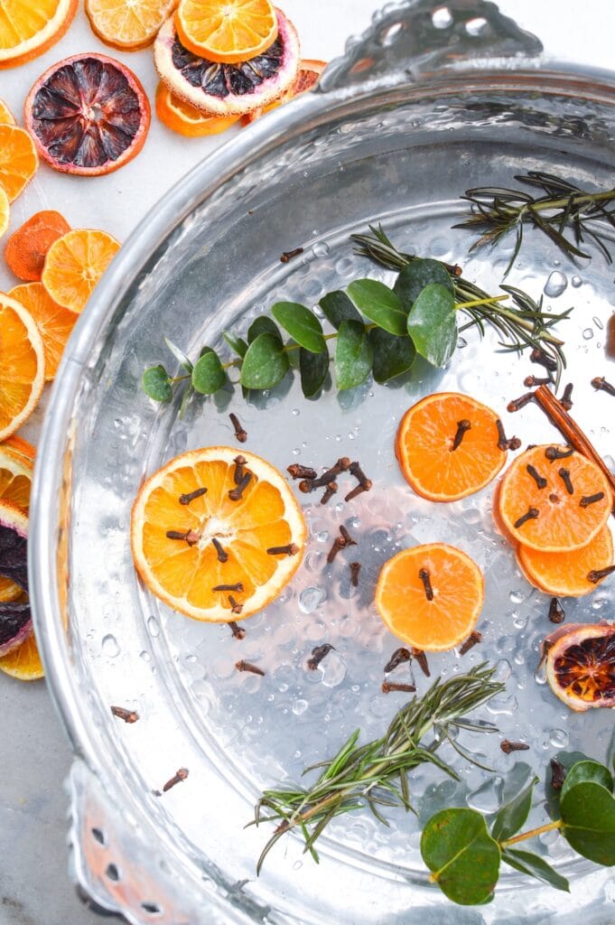 orange slices eucalyptus and cloves in silver pot