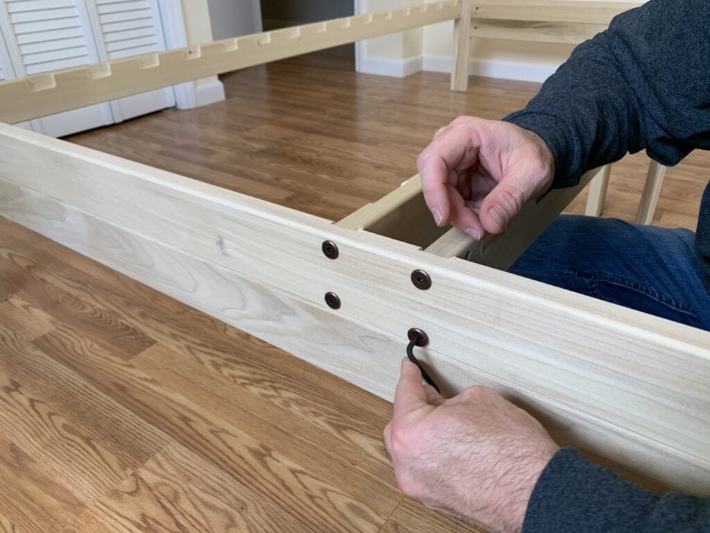 solid wood platform bed frame being put together