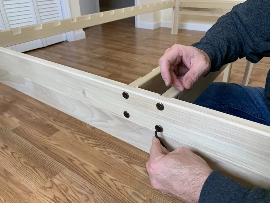 solid wood platform bed frame being put together