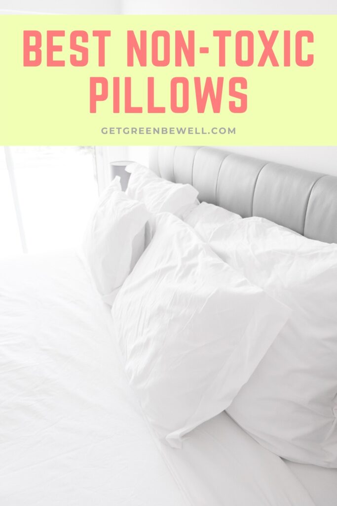 white pillow cases on bed pillows against grey headboard