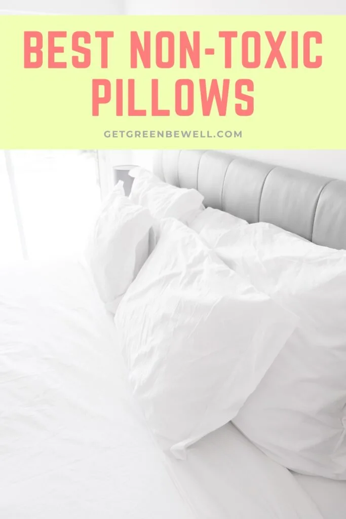 white pillow cases on bed pillows against grey headboard