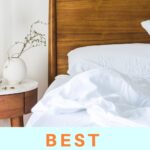 white sheets on bed against wooden headboard on white wall