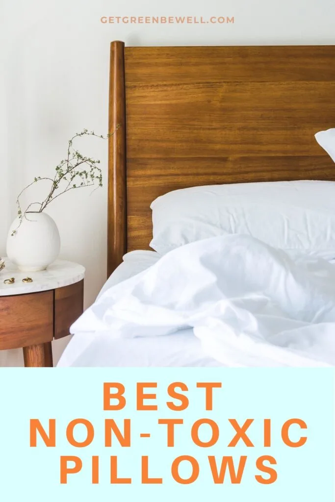 white sheets on bed against wooden headboard on white wall