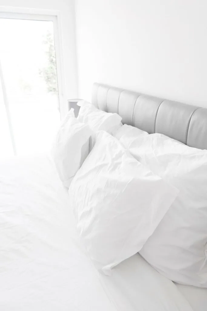white bed pillows on white sheets 