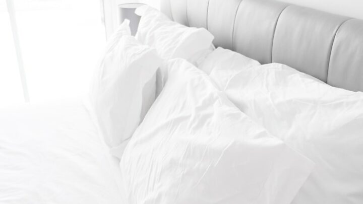 white bed pillows on white sheets