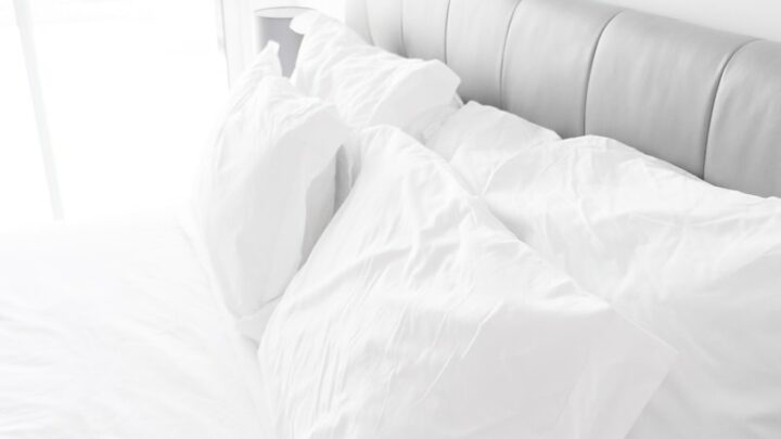 white bed pillows on white sheets