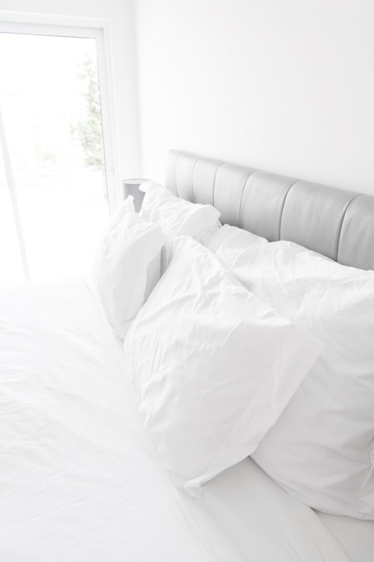 white bed pillows on white sheets