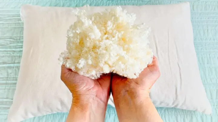 woman holding wool latex fill from customizable pillow