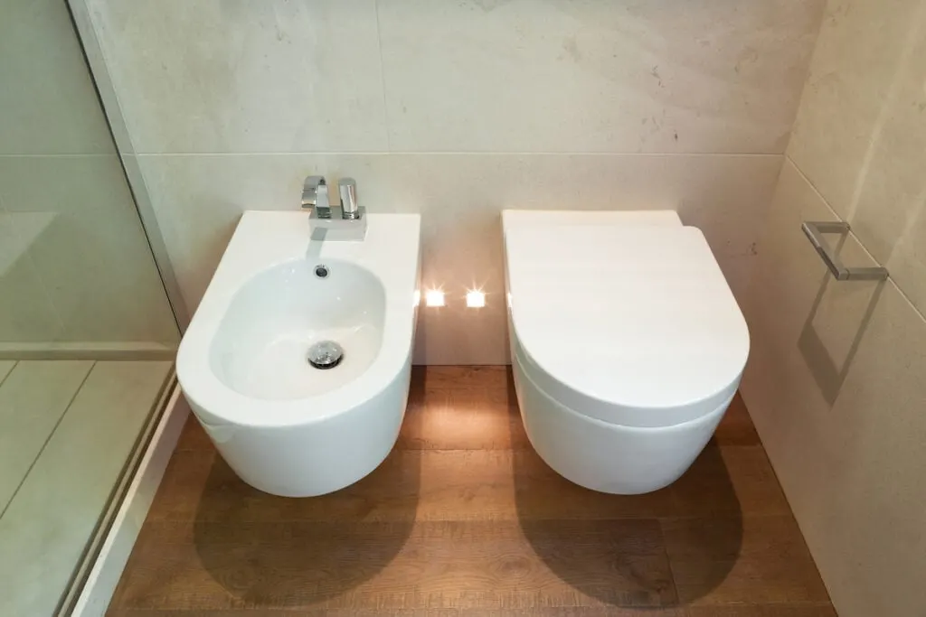 white toilet and bidet in bathroom