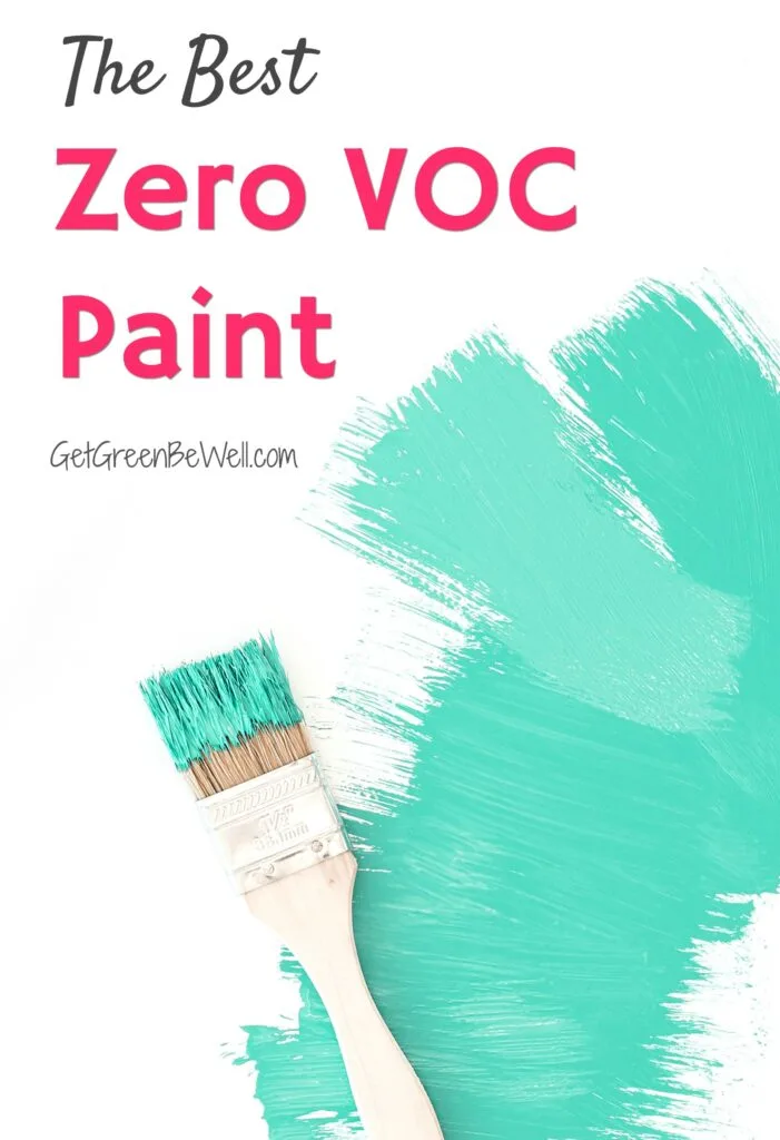 green paint on white wall with paint brush nearby