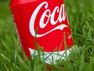 red Coke can in green grass