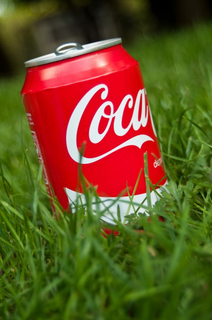 red Coke can in green grass