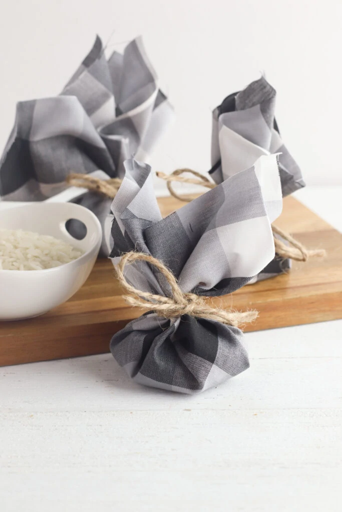 bowl of rice on wooden cutting board with dresser sachets 