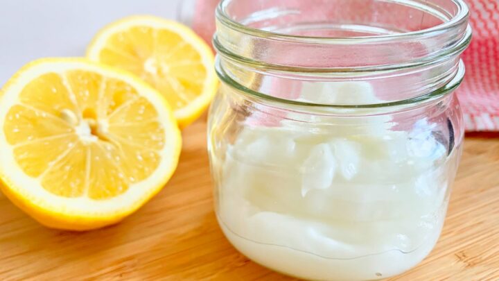 non toxic white gel cleaner in small mason jar next to cut lemons