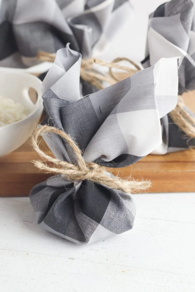 sachet bag on white table next to wooden cutting board