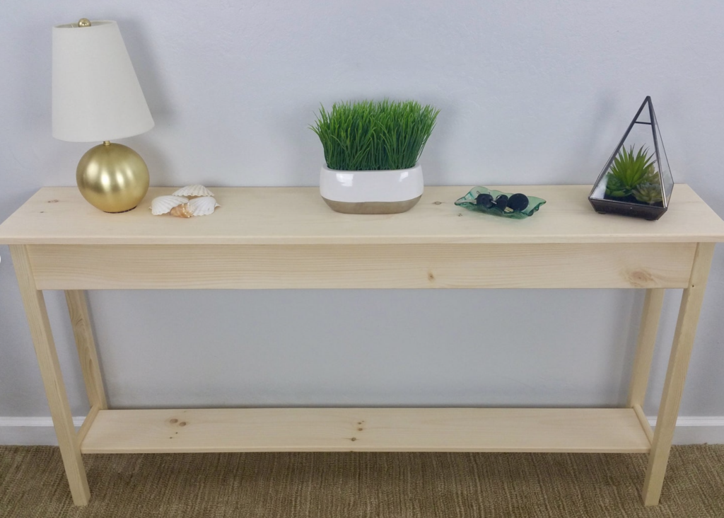 unfinished wood table with lamp and plant on top