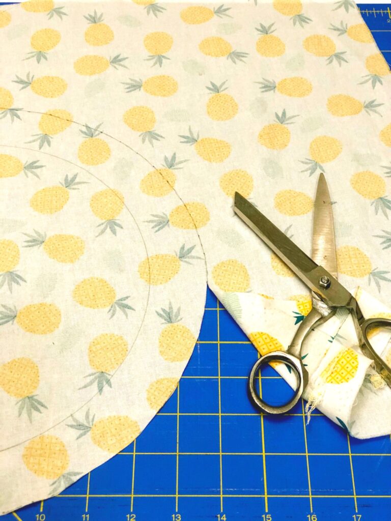 fabric cut into a circle with scissors nearby