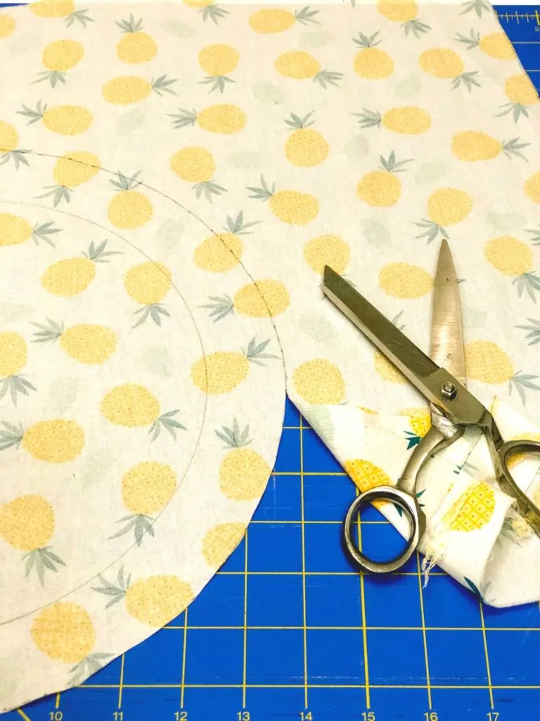 fabric cut into a circle with scissors nearby