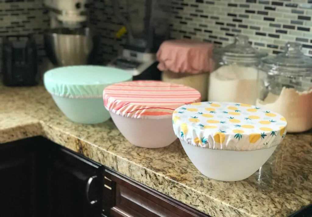 reusable fabric bowl covers on plastic bowls on kitchen countertop