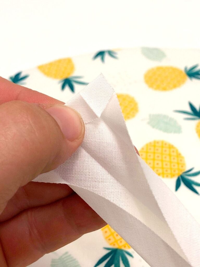 https://www.getgreenbewell.com/wp-content/uploads/2020/06/Folding-bias-tape-on-end-for-sewing-768x1024.jpg