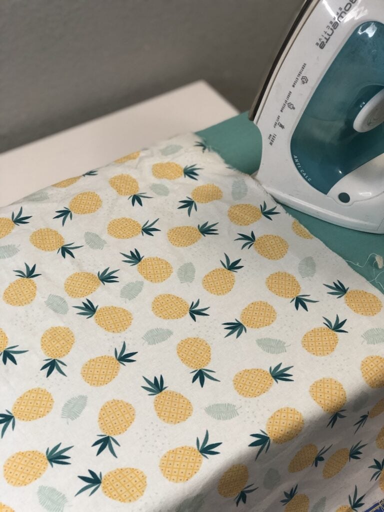 pineapple fabric on ironing board near iron