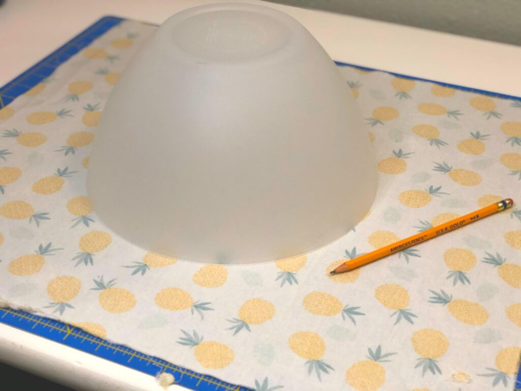 upside down bowl on pineapple fabric with pencil nearby