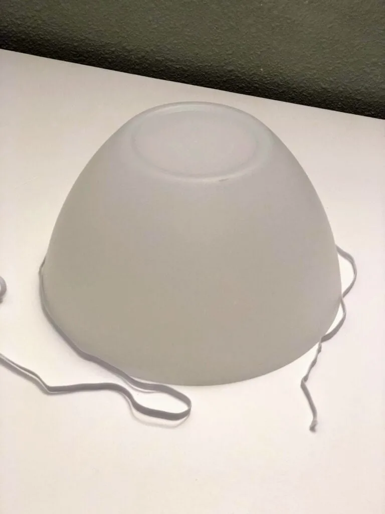 white elastic wrapped around white upside down bowl