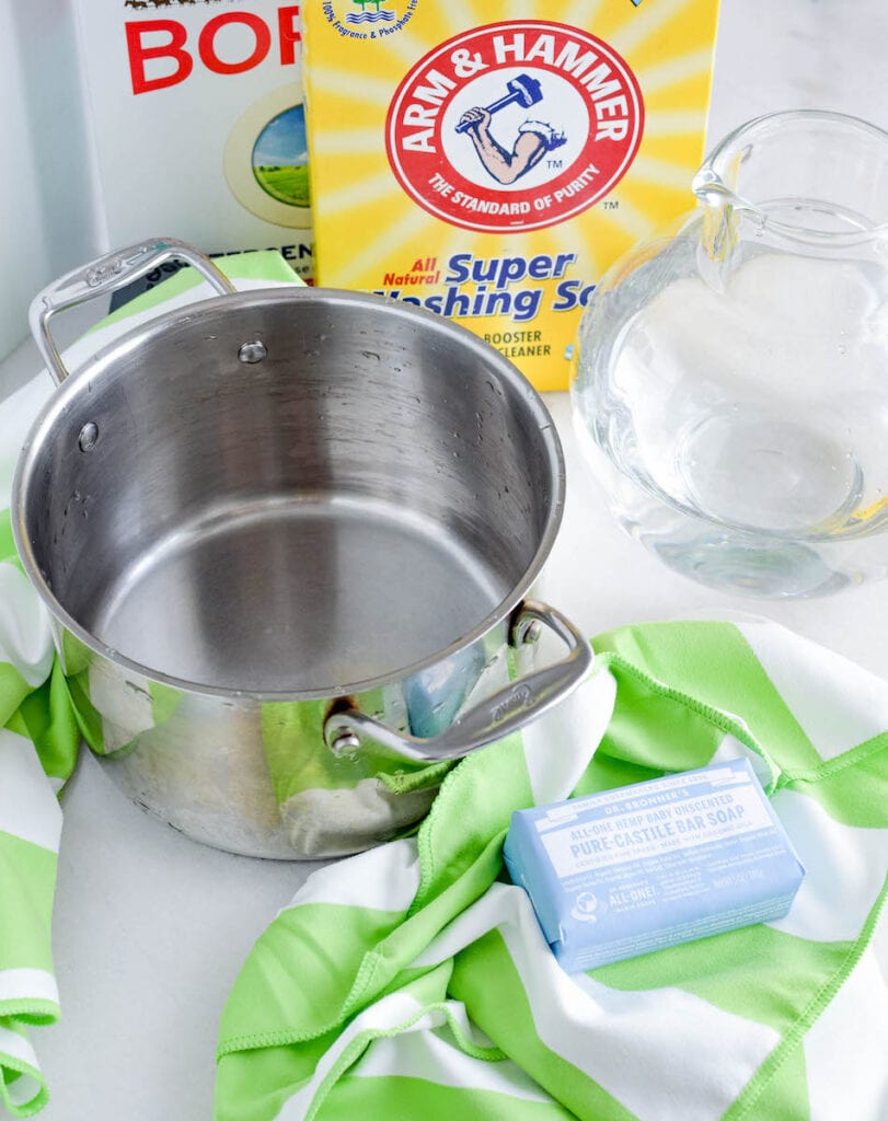 pot with pitcher of water and bar of soap next to box of washing soda
