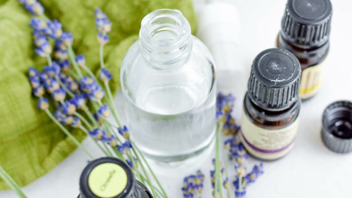 glass bottle and essential oil bottles with lavender flowers