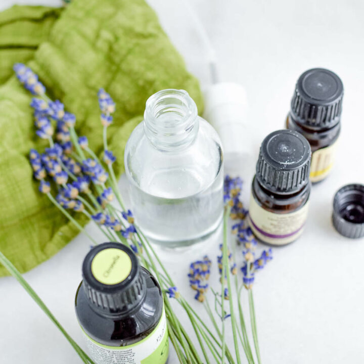 glass bottle and essential oil bottles with lavender flowers