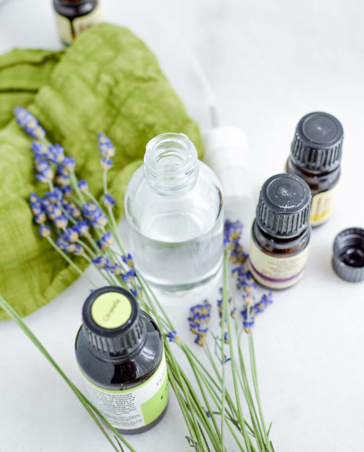 glass bottle and essential oil bottles with lavender flowers