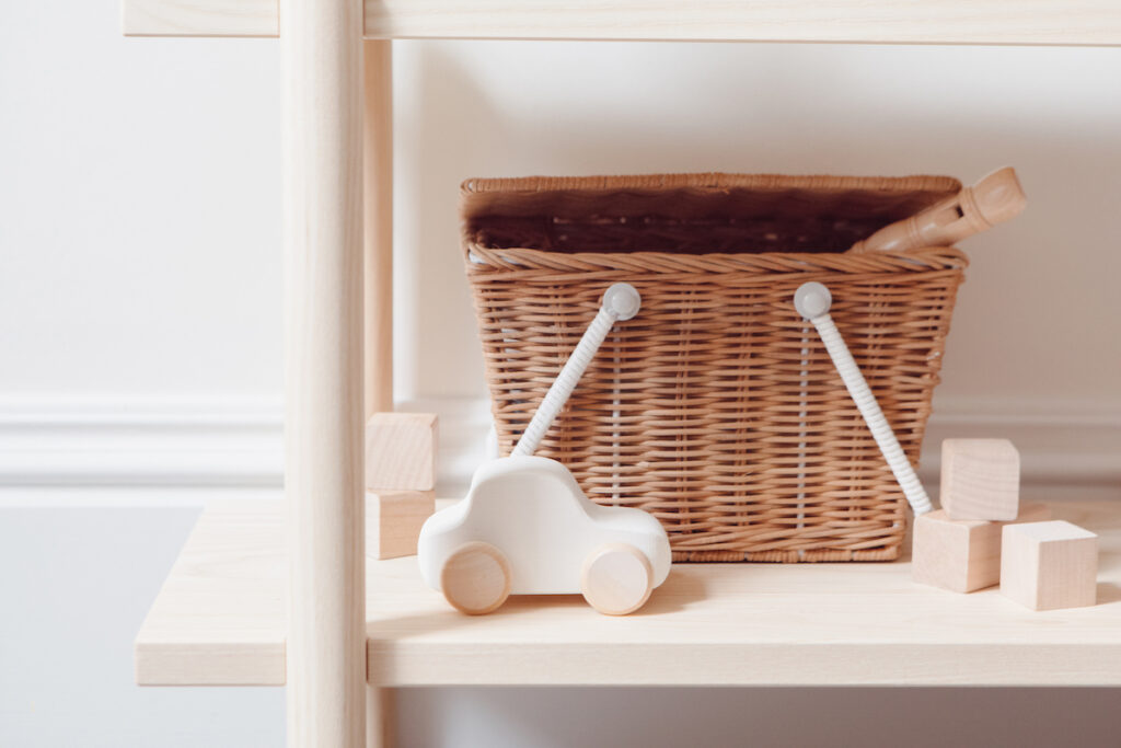 wicker basket with kids toys on a shelf