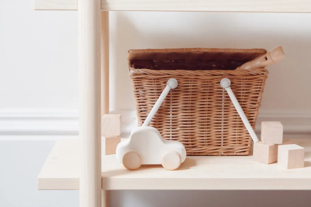 wicker basket with kids toys on a shelf
