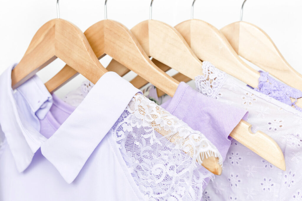 purple shirts on wooden hangers