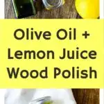 A bottle of olive oil, lemons, and a metal tin on a wooden table with a jar of mixed polish and a lemon on a cloth below. Text reads: "Olive Oil + Lemon Juice Wood Cleaner.