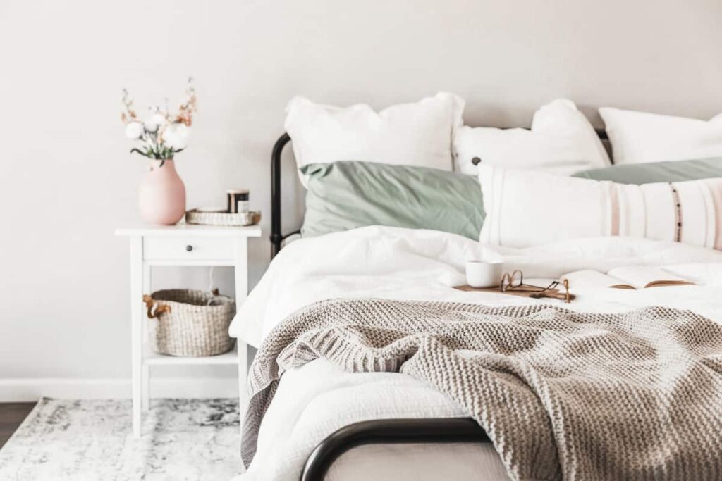 bed with lots of pillows in a bedroom